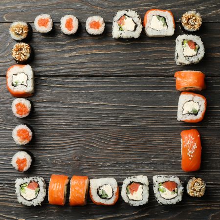Flat lay with sushi rolls on wooden background. Japanese food