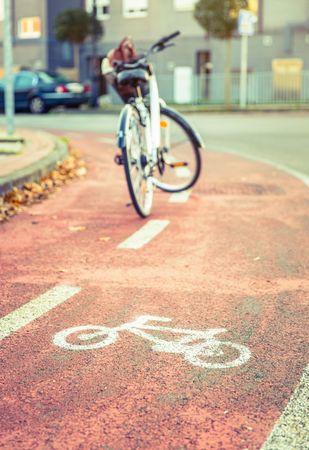 Bike lane marking in foreground of parked bicycle