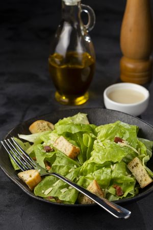 Caesar salad with croutons and bacon.