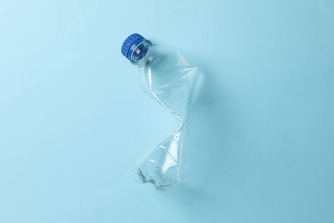 Used plastic water bottle on blue table