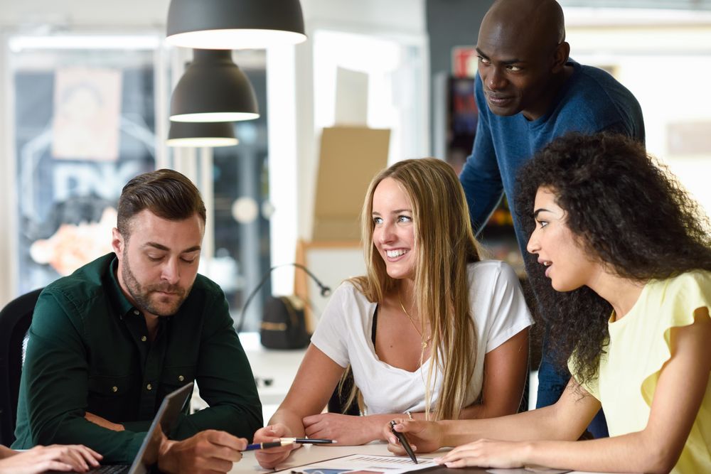 Multi-ethnic group working in office together