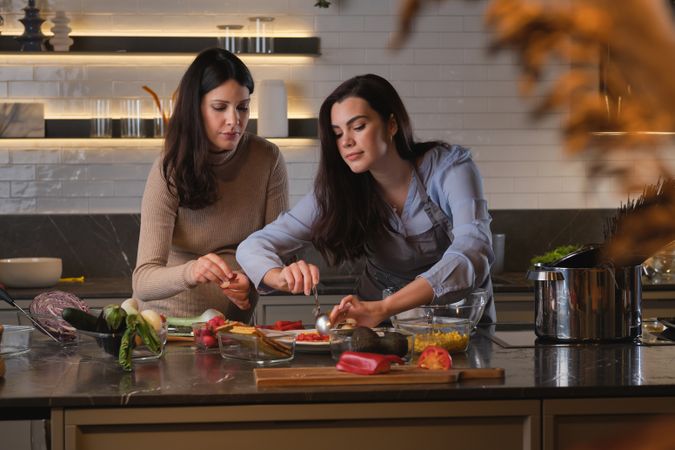 Concentrated ladies preparing healthy meal together