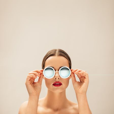 White female fashion model posing with glasses