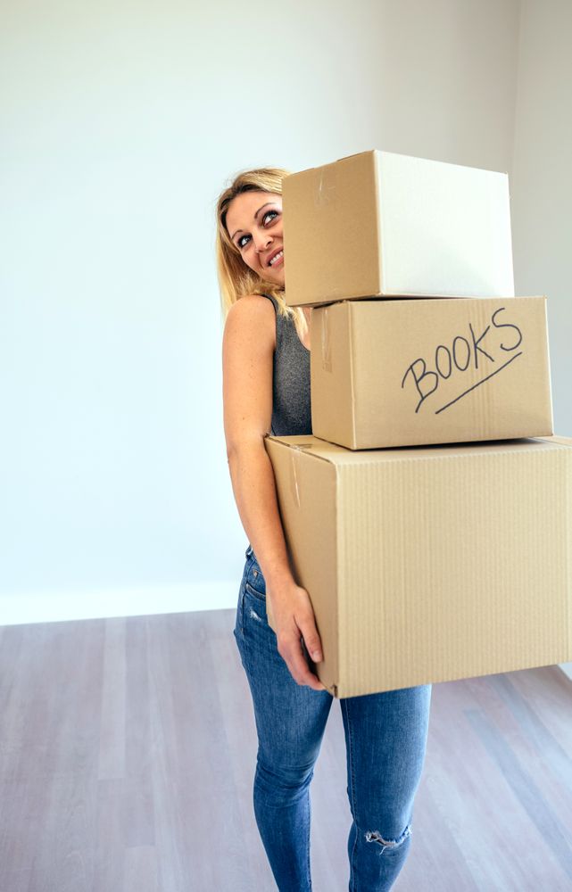 Woman carrying moving boxes