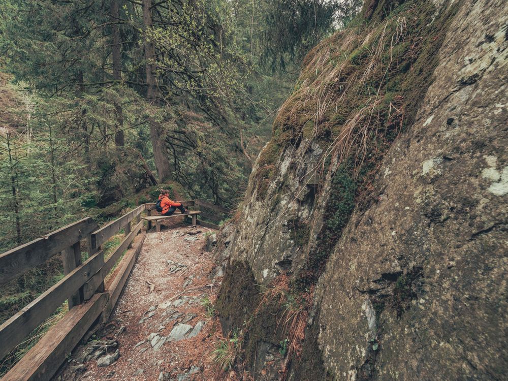 Hiker resting while walking on path