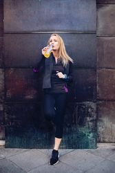 Woman drinking isotonic drink while resting