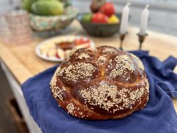 Homemade braided challah bread in traditional round shape for Rosh Hashanah holiday