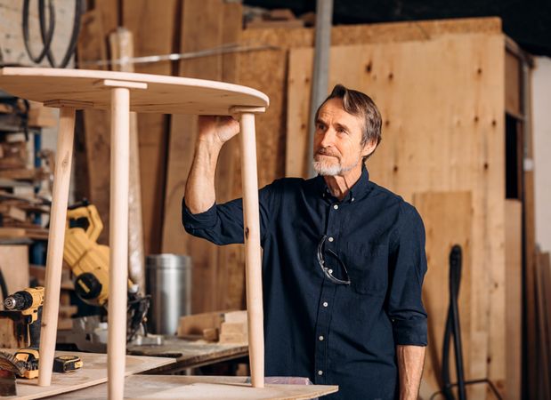 Man checking table he built