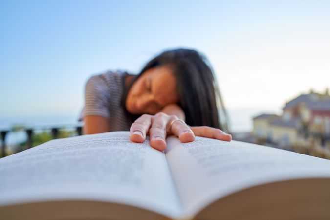Woman with book on balcony
