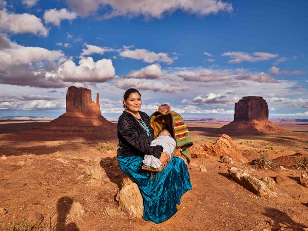 Navajo woman posing with baby in Monument Valley, AZ