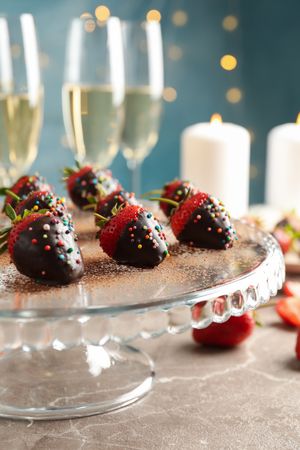 Composition with chocolate fondue on gray table. Delicious sweet food