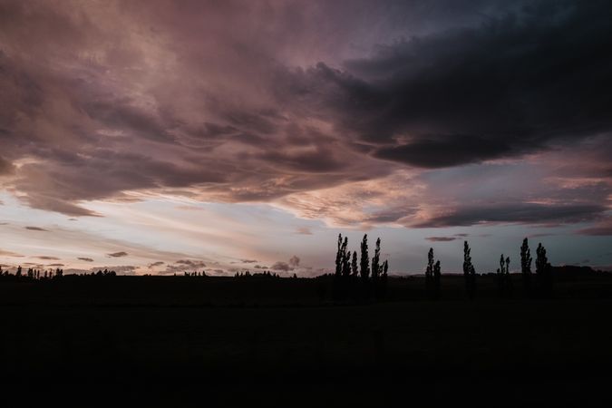 Evening cloudy sky above dark field