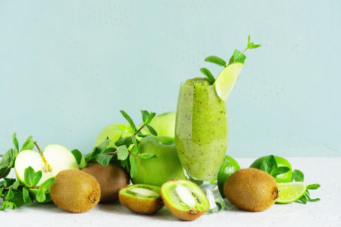 Blended kiwi and apple juice in tall glass