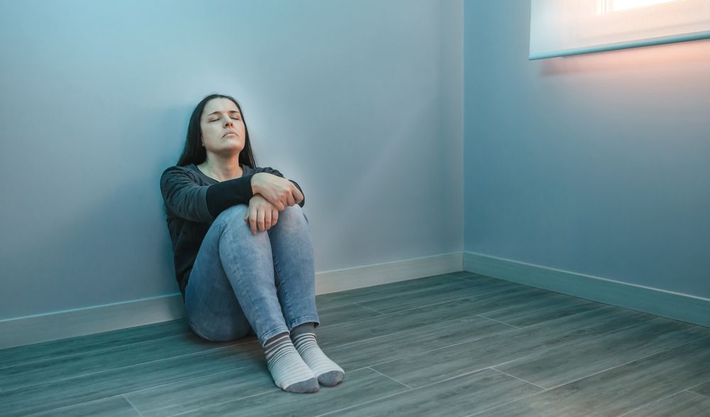 Stressed woman sitting with closed eyes relaxing