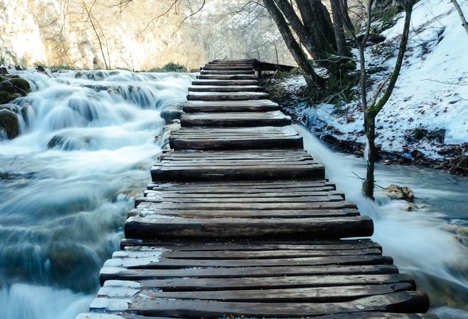 Wooden Foot Bridge over waterfalls.