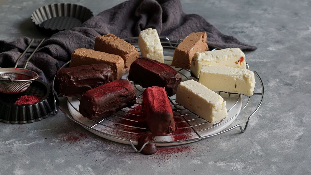 Chocolate and strawberry cakes near bows with ingredients