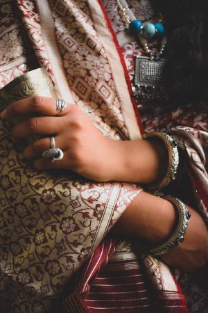 Close-up shot of woman wearing sari holding a cup