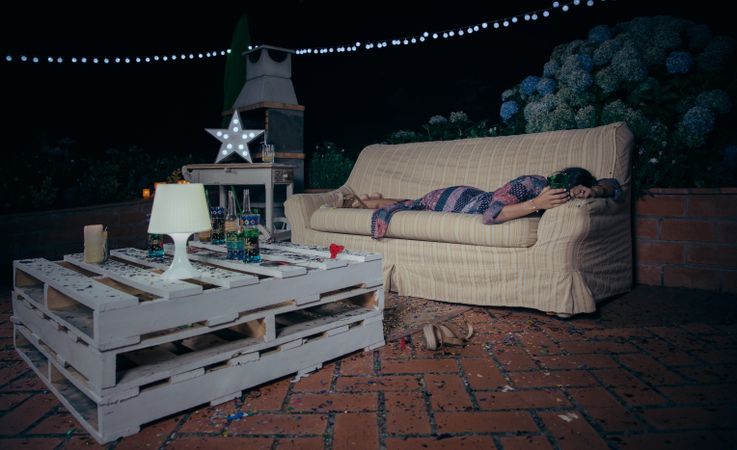 Woman sleeping on a sofa after party