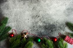 Christmas frame with branches on stone background