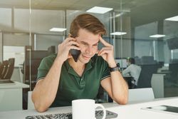 Male having phone conversation at work