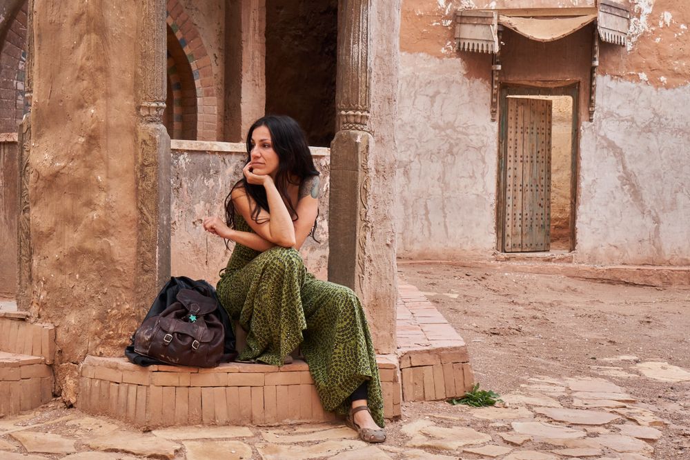 Woman on street between ancient buildings