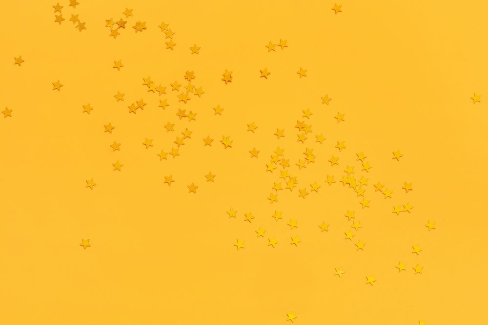 Golden stars on vibrant yellow background