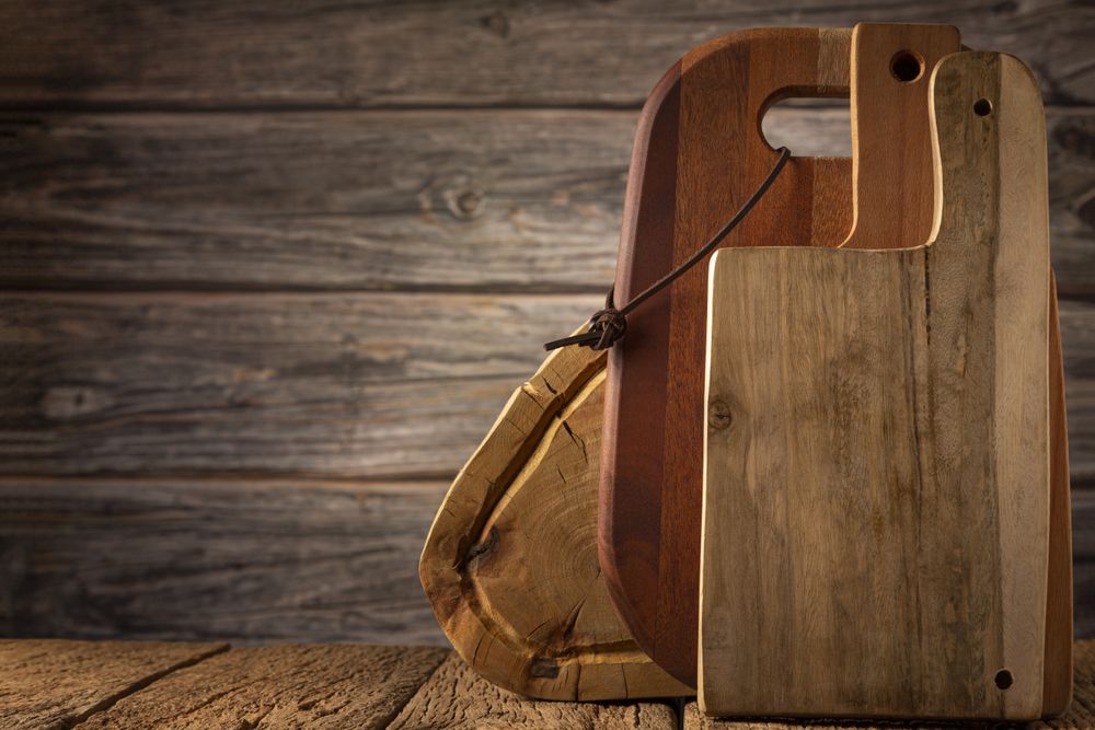 Wooden kitchen utensils on rustic background.
