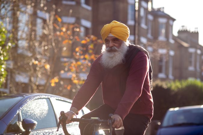 Sikh man in turban cycling through British town