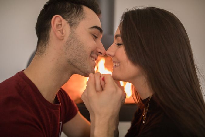 Couple sitting near fireplace