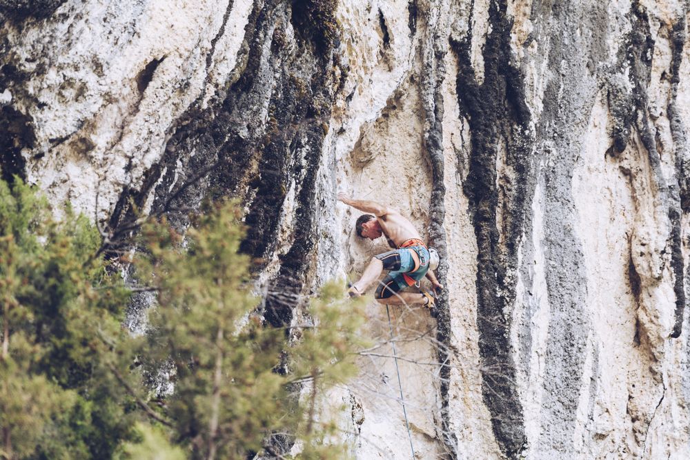 Anonymous man climbing rock