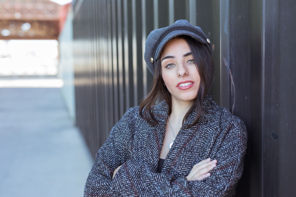 Charming Hispanic woman near wall