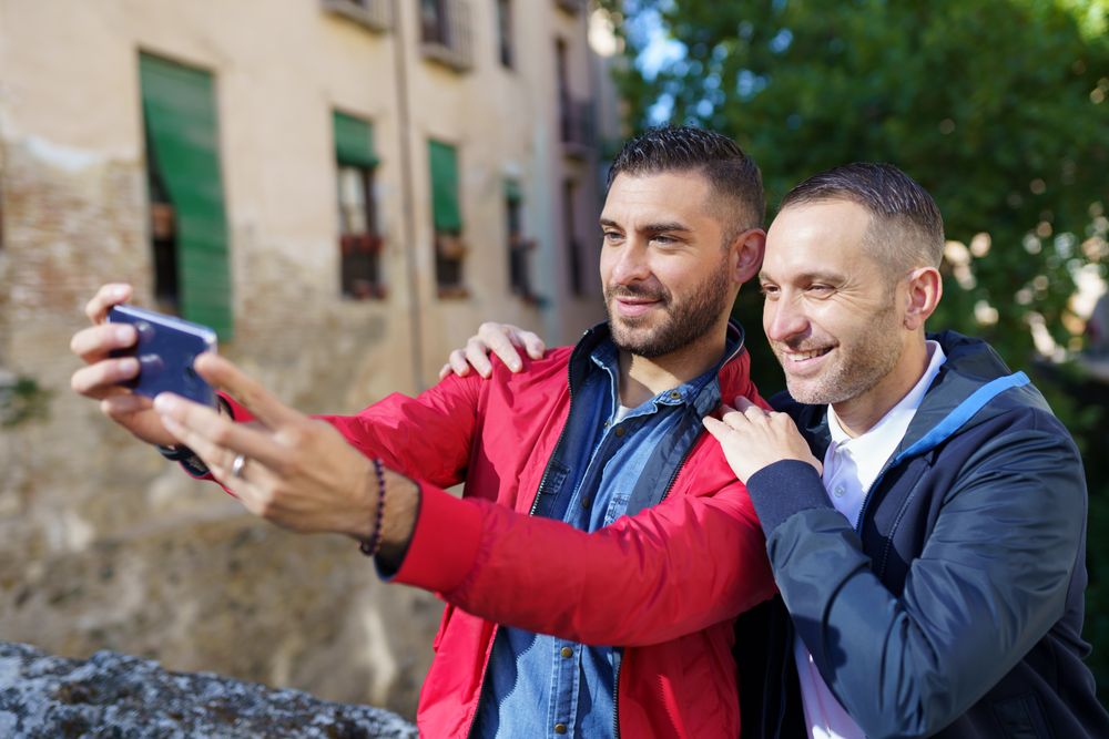 Two men taking selfie outside