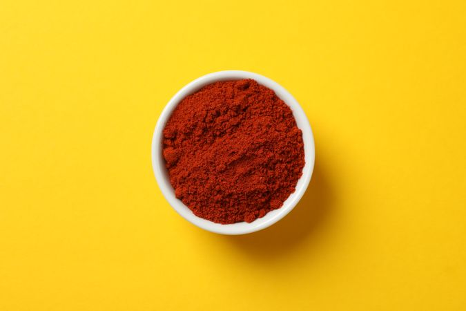 Top view of red pepper powder in ceramic bowl