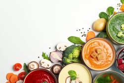 Colorful soups in corner of picture with copy space