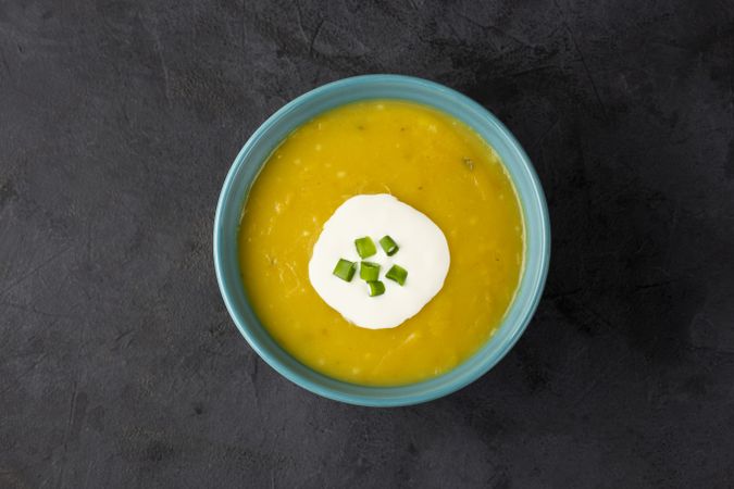 Bowl with pumpkin soup on the table.
