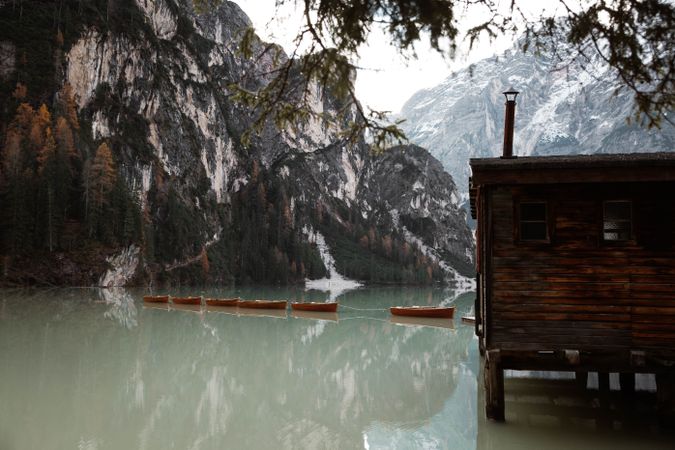 House on stilts on lake near mountains
