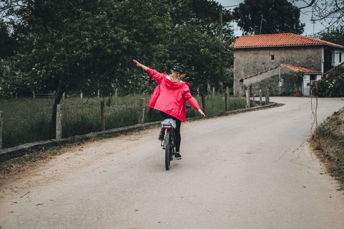 Female riding bicycle without hands