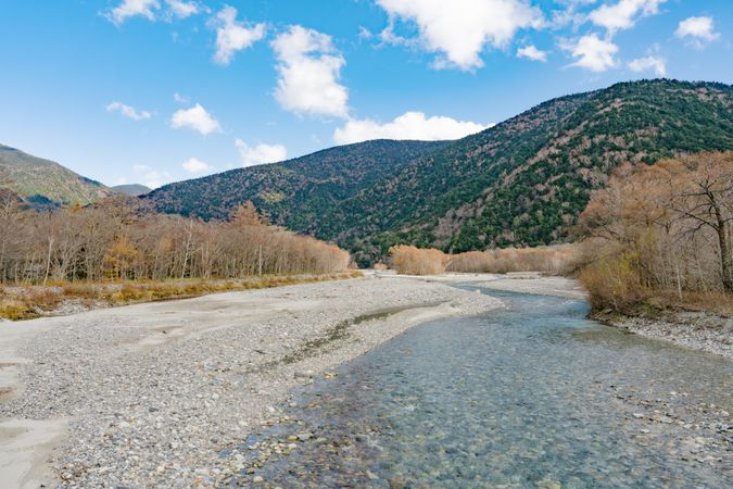 landscape view of japan alps mountain with natural forest, blue river on autumn season at kamikochi Nagano.