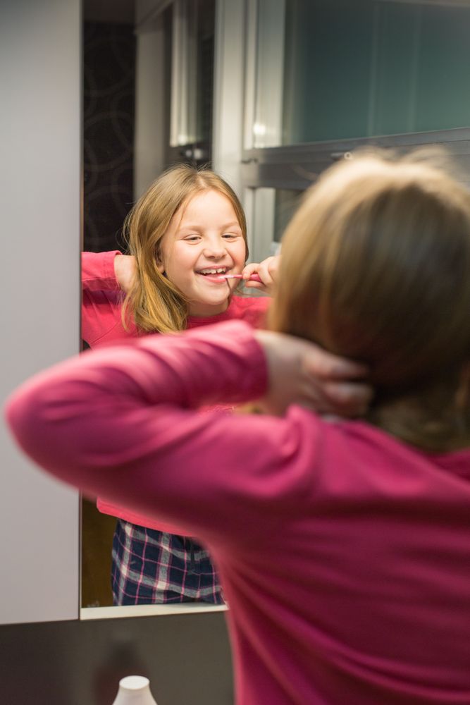 Cute girl brushing her teeth