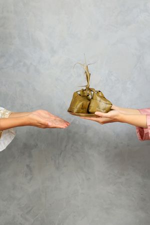 Sharing Ketupat, Two Female Sharing Diamond Shape Rice Cake