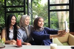 Three Asian Female Friends Taking Selfie on Mobile Phone