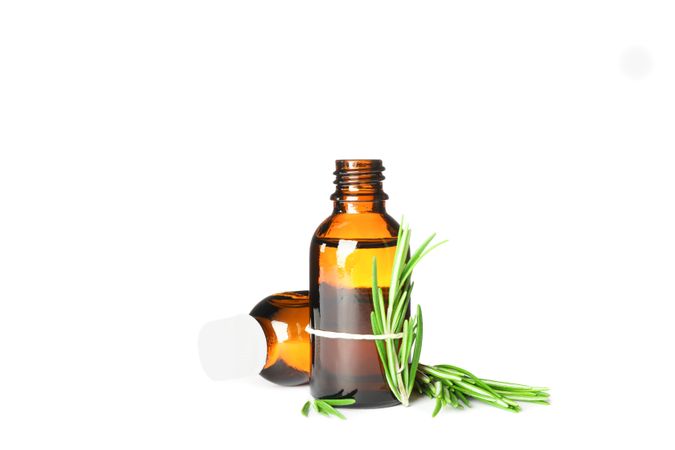 Rosemary oil in jars isolated on neutral background