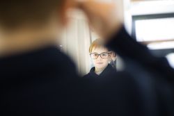Young boy trying on glasses