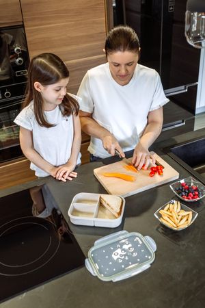 Mother preparing healthy snack for her daughter for school