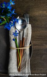 Spring table setting with blue scilla laying on napkin 5nggX2