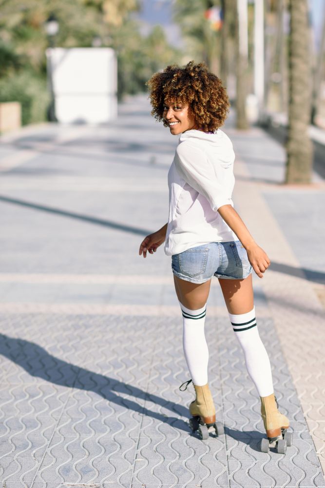 Woman on roller skates looking back at camera, vertical