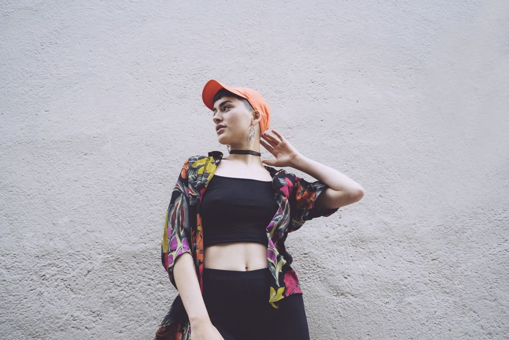 Woman in orange cap looking away