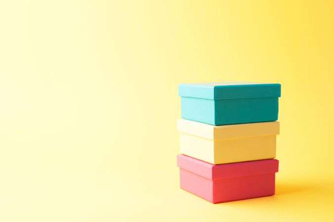 Three stacked boxes on yellow background right of frame
