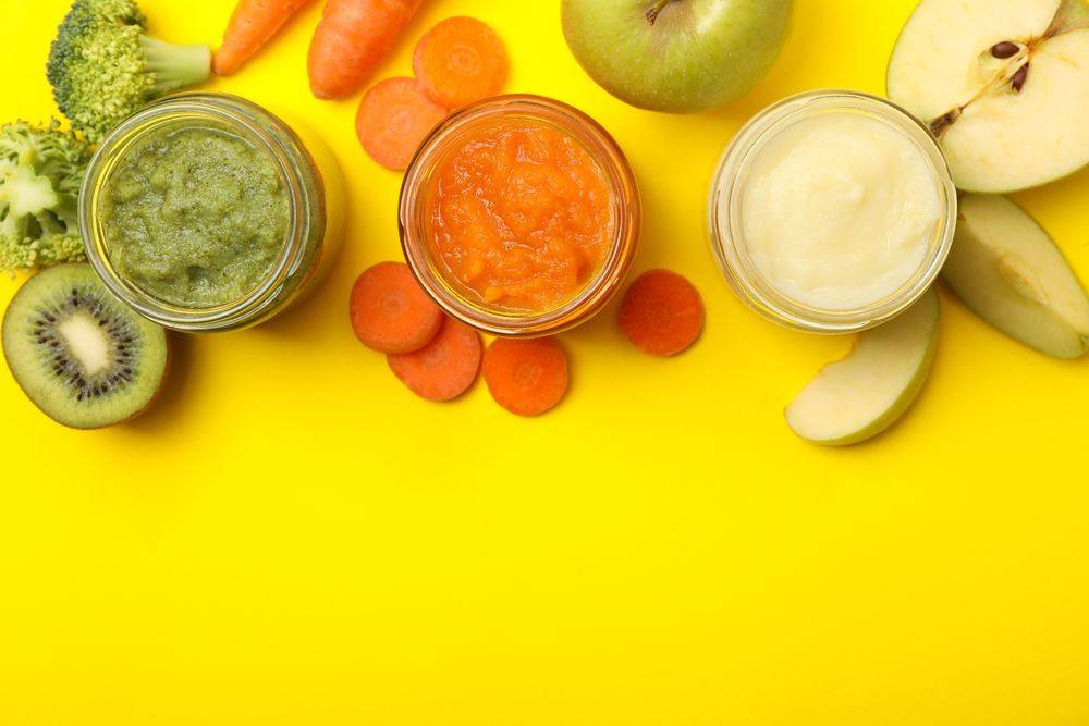 Composition with vegetable puree on yellow background. Baby food