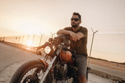 Strong man driving motorcycle